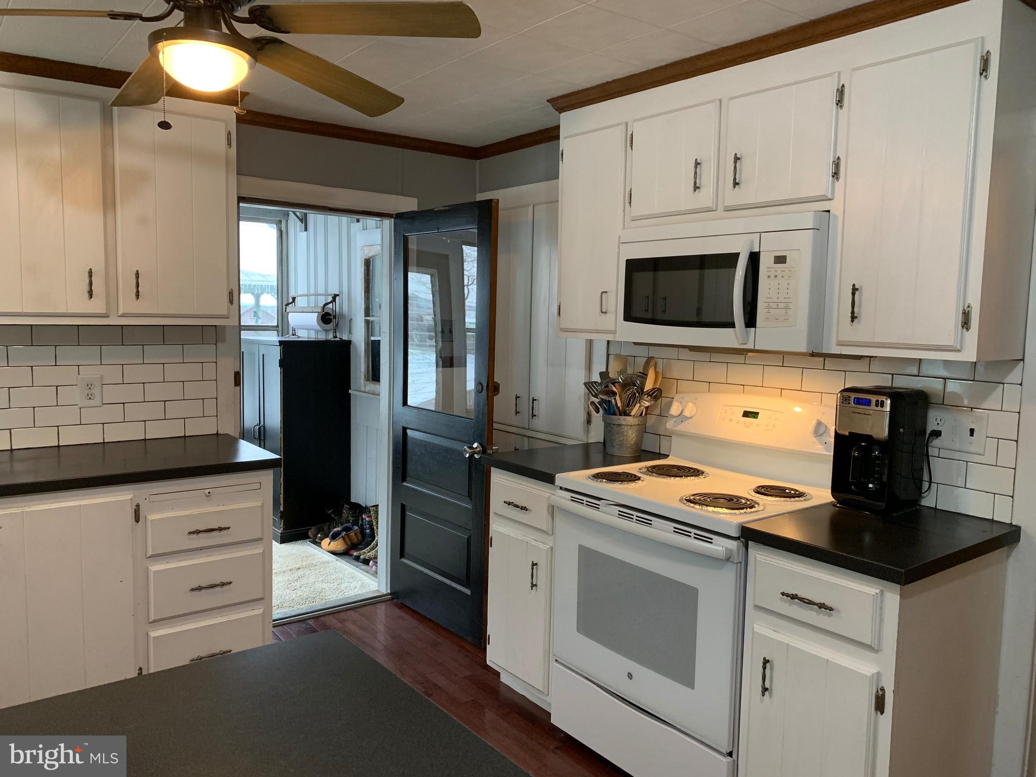 3317 River Road Conestoga, PA 17516 - Photo 3 of 33 a kitchen with granite countertop white cabinets and stainless steel appliances