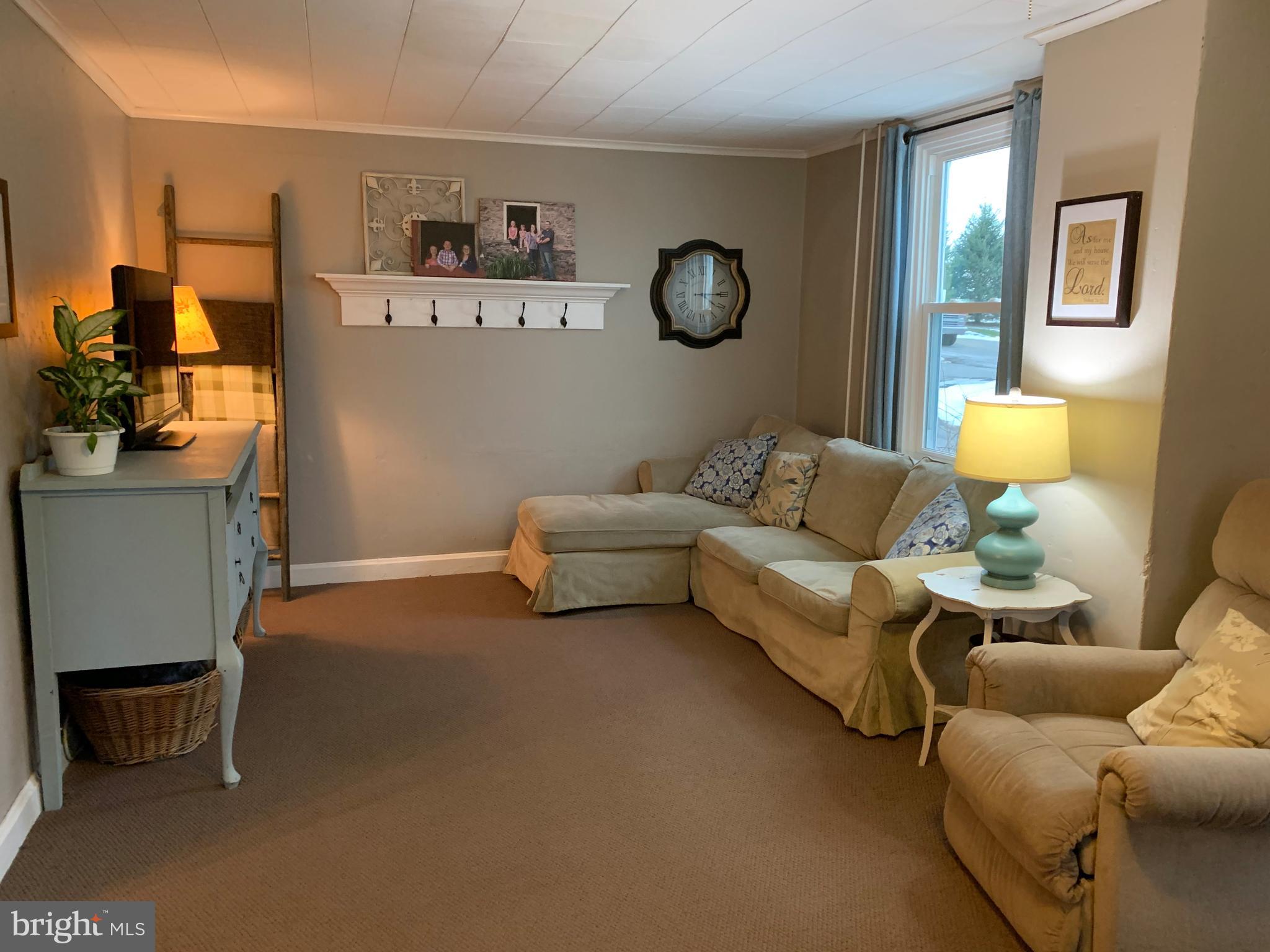 3317 River Road Conestoga, PA 17516 - Photo 10 of 33 a living room with furniture and a lamp