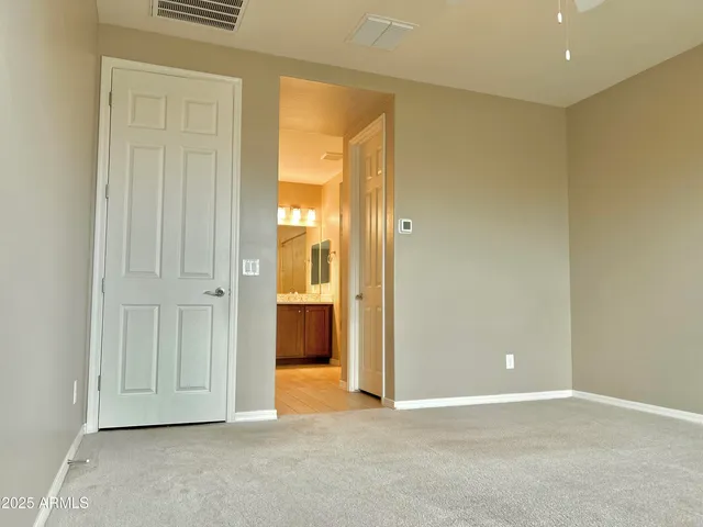 an empty room with windows and closet