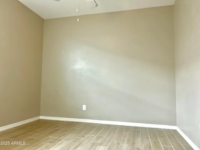 a view of a room with wooden floor