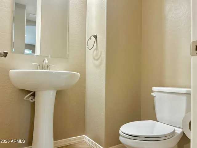 a bathroom with a sink a mirror and a toilet