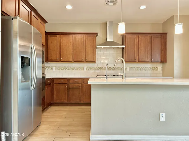 a kitchen with stainless steel appliances granite countertop a refrigerator and a sink