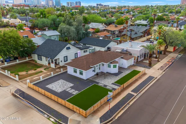 an aerial view of a tennis ground and a lots of residential buildings