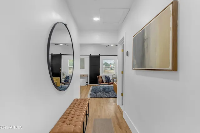 a view of a living room and bathroom with a mirror