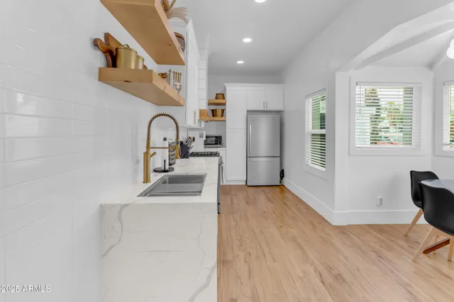 a kitchen with a sink cabinets and wooden floor