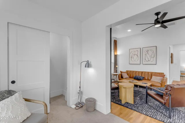 a living room with furniture and a ceiling fan