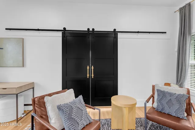 a living room with furniture and a air conditioner vent