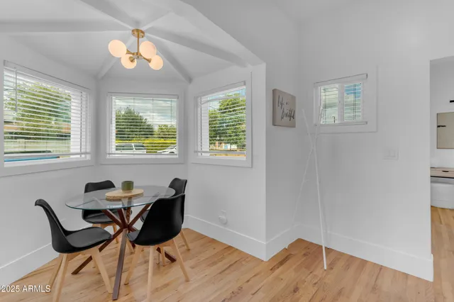 a workspace with wooden floor and a window