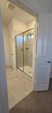 a bathroom with a glass shower door