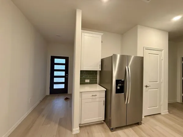 a kitchen with stainless steel appliances a refrigerator and a stove top oven