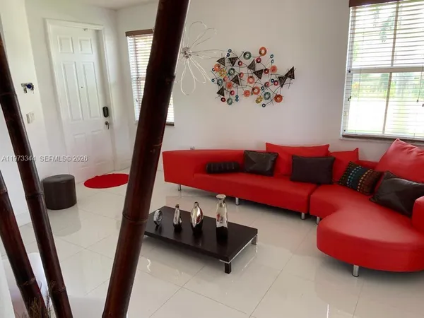 a dining room with furniture and window