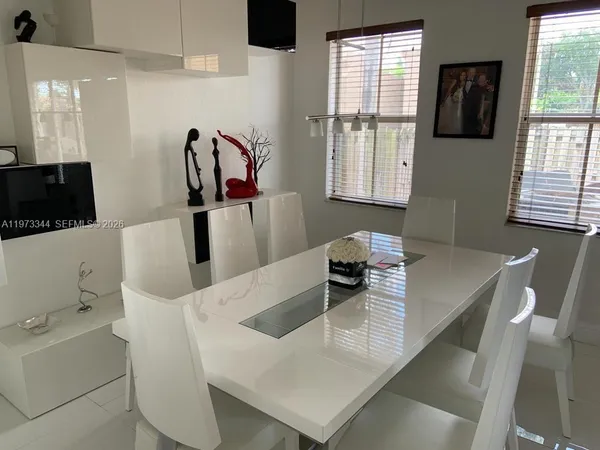 a living room with furniture gym equipment and view of bathroom