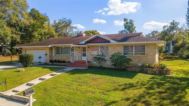 a front view of a house with swimming pool having outdoor seating