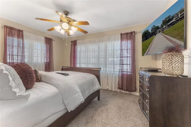 a bedroom with a bed dresser and a window