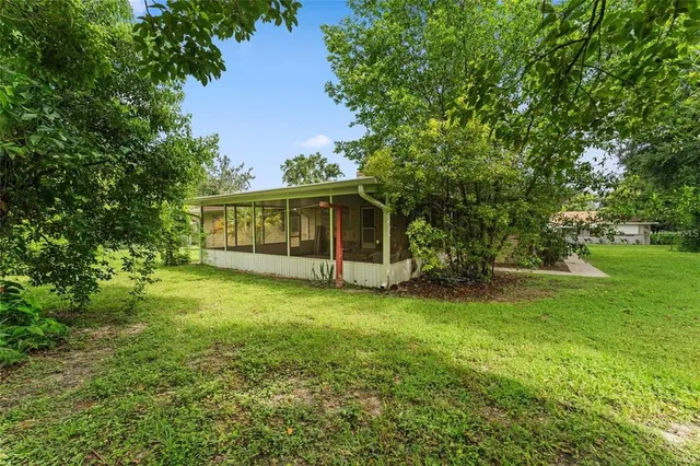 a view of a house with a backyard