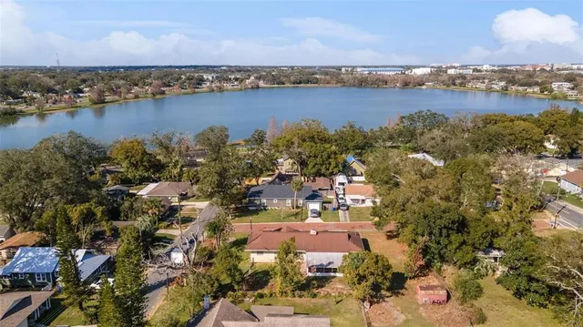 an aerial view of ocean and residential houses with outdoor space and ocean