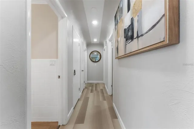 a view of a hallway with wooden floor