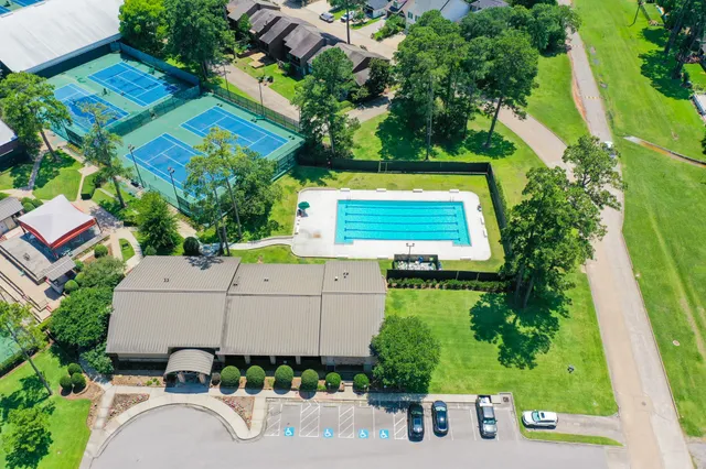 an aerial view of a house with a garden and swimming pool