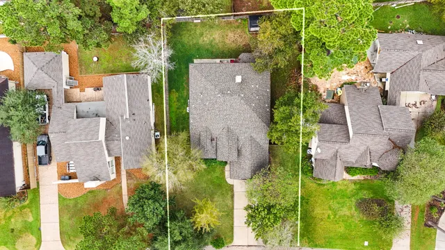 an aerial view of a house with a yard basket ball court and outdoor seating