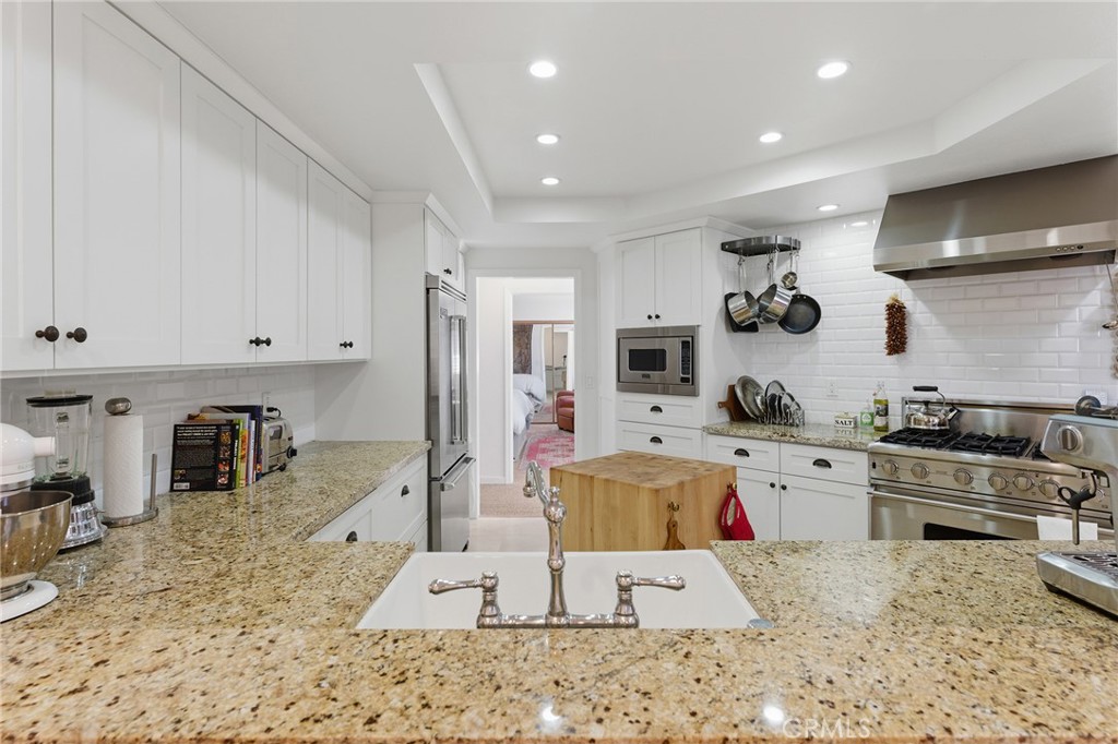 27843 Parker Road Castaic, CA 91384 - Photo 20 of 61 a large kitchen with stainless steel appliances kitchen island granite countertop a sink and cabinets