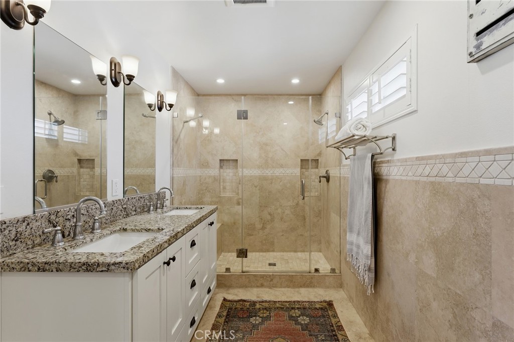 27843 Parker Road Castaic, CA 91384 - Photo 32 of 61 a bathroom with a granite countertop sink a shower and a mirror