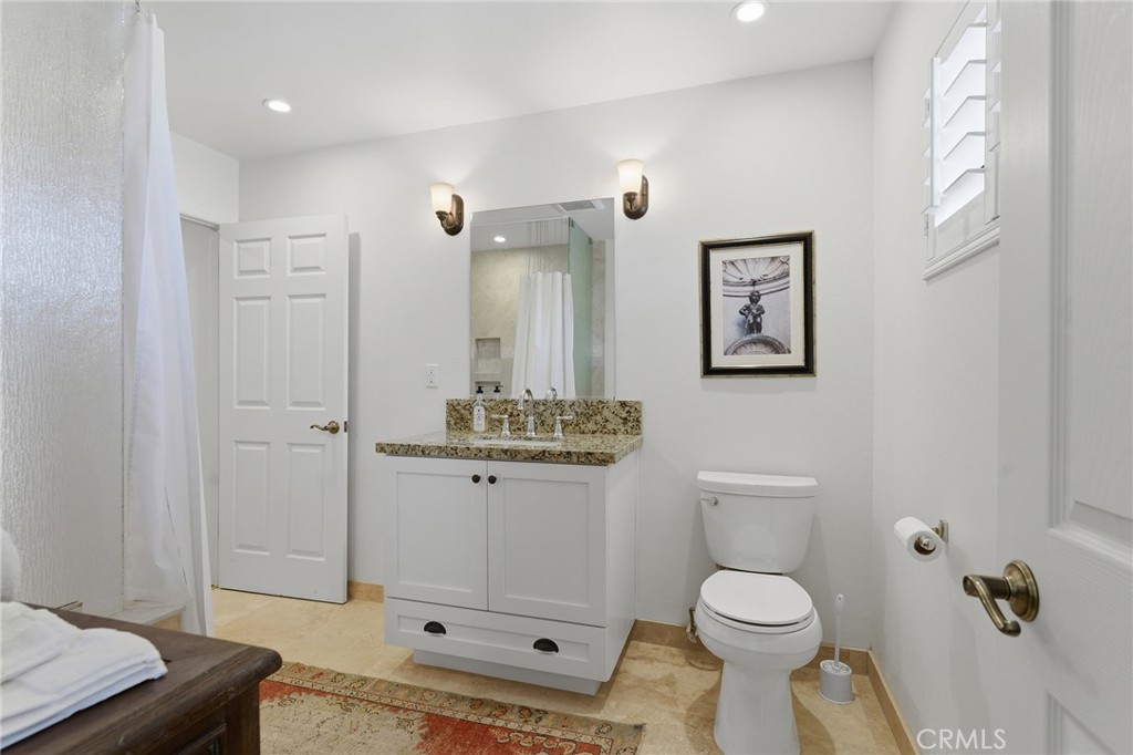 27843 Parker Road Castaic, CA 91384 - Photo 36 of 61 a bathroom with a toilet a sink and mirror