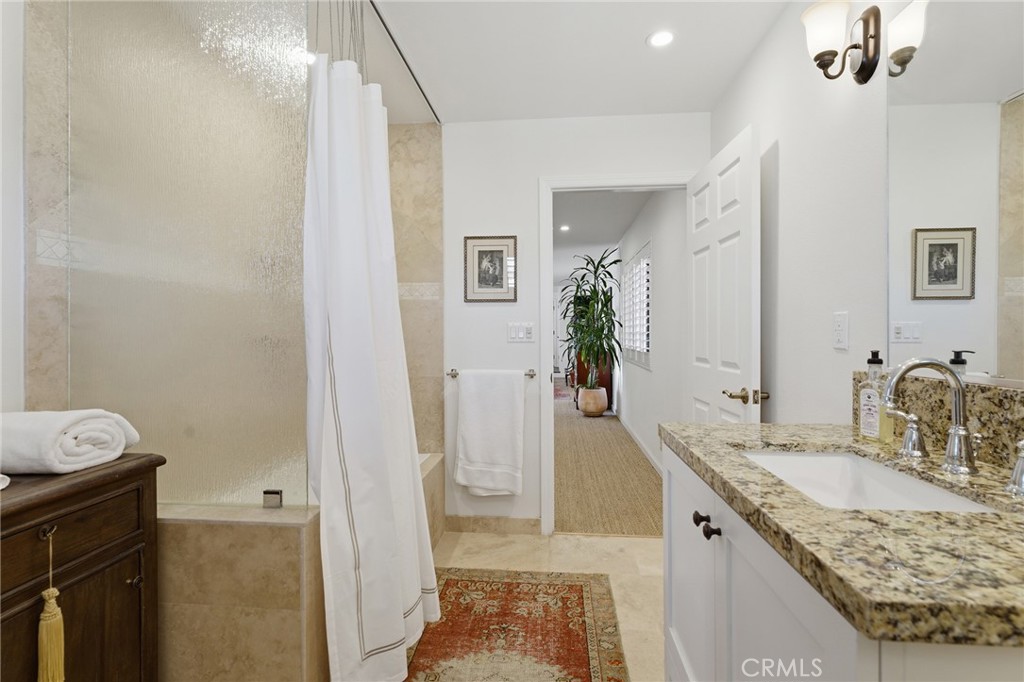 27843 Parker Road Castaic, CA 91384 - Photo 37 of 61 a bathroom with a granite countertop sink a mirror and a shower