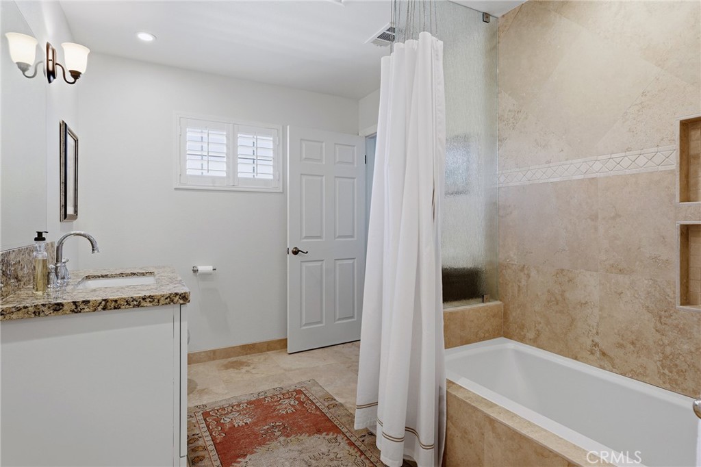 27843 Parker Road Castaic, CA 91384 - Photo 38 of 61 a bathroom with a granite countertop sink a bathtub and shower