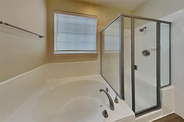 a bathroom with a bathtub and a shower