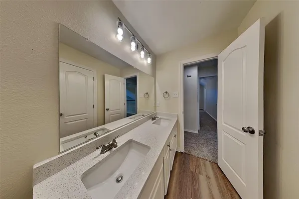 a bathroom with a double vanity sink and mirror