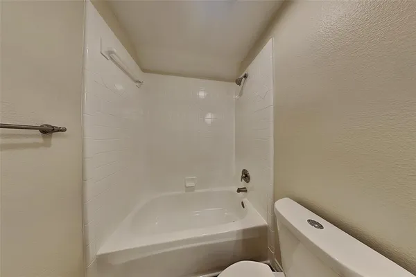 a bathroom with a bathtub and a toilet