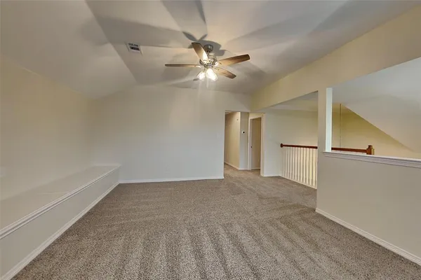 a view of a livingroom with a ceiling fan and wooden floor
