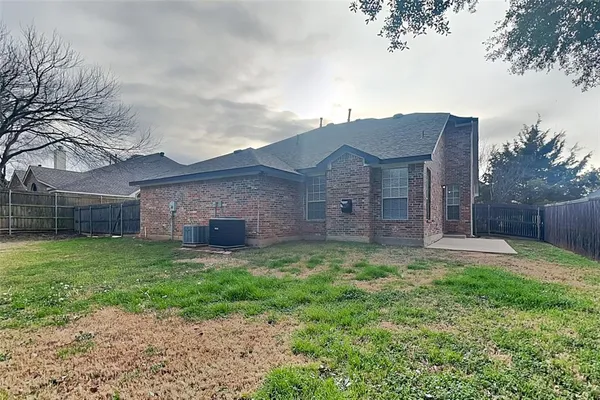 a view of a house with a yard and pathway