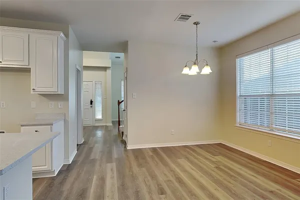a view of a room with wooden floor and windows