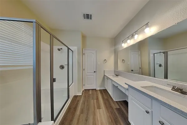 a spacious bathroom with a double vanity sink and a mirror