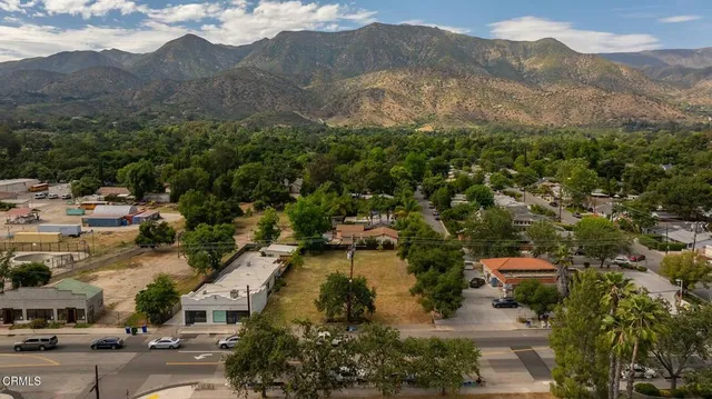 an aerial view of residential house with green space
