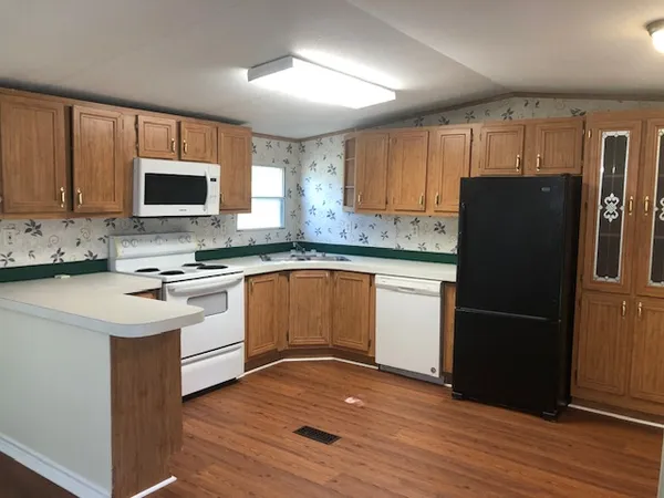 a kitchen with a refrigerator stove and microwave