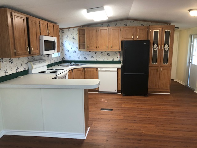 302 North Burnet Street Bremond, TX 76629 - Photo 11 of 41 a kitchen with a refrigerator sink and microwave