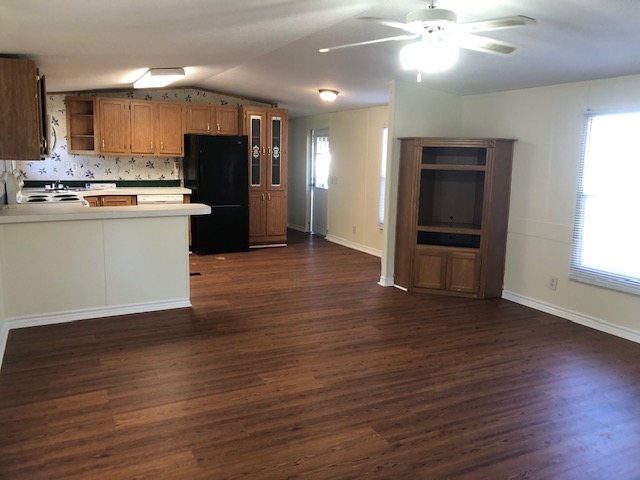 302 North Burnet Street Bremond, TX 76629 - Photo 12 of 41 an open kitchen with wooden floor and stainless steel appliances