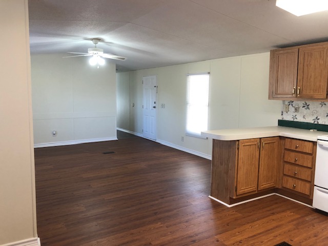 302 North Burnet Street Bremond, TX 76629 - Photo 13 of 41 a view of an empty room with wooden floor and a window