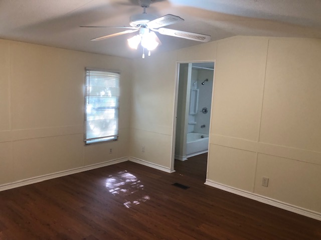 302 North Burnet Street Bremond, TX 76629 - Photo 19 of 41 wooden floor in an empty room with a window