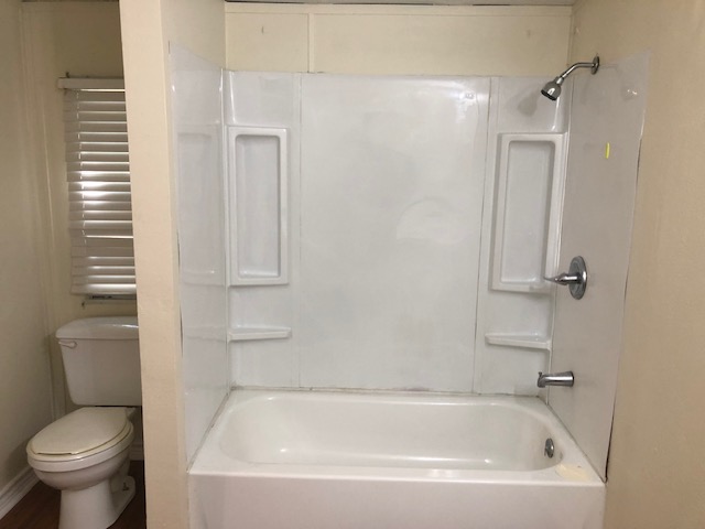 302 North Burnet Street Bremond, TX 76629 - Photo 23 of 41 a white bath tub sitting next to a toilet
