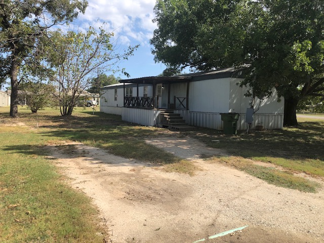 302 North Burnet Street Bremond, TX 76629 - Photo 27 of 41 a view of a house with a yard covered in snow