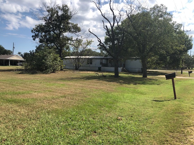 302 North Burnet Street Bremond, TX 76629 - Photo 30 of 41 a swimming pool with outdoor seating and yard