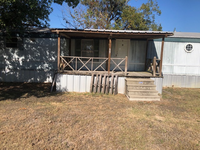 302 North Burnet Street Bremond, TX 76629 - Photo 3 of 41 a view of a chair and table in the back yard of the house