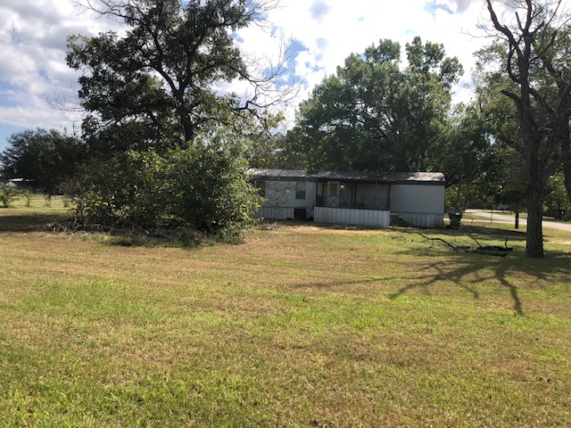 302 North Burnet Street Bremond, TX 76629 - Photo 32 of 41 a view of a swimming pool with an outdoor seating and a yard