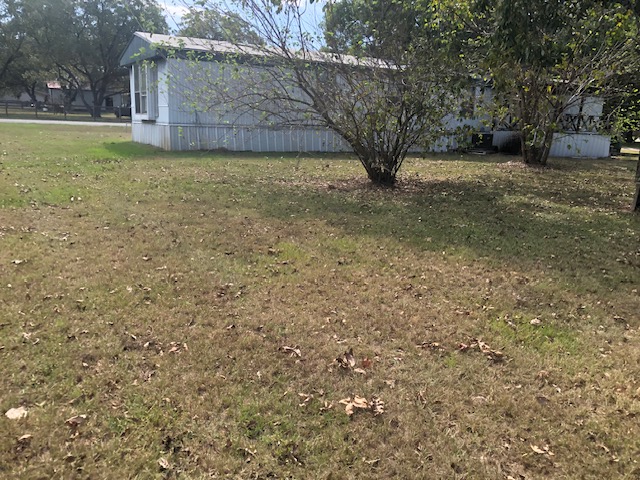 302 North Burnet Street Bremond, TX 76629 - Photo 34 of 41 a view of a backyard with large trees