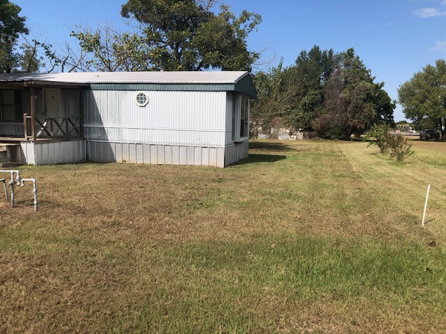 302 North Burnet Street Bremond, TX 76629 - Photo 37 of 41 a view of a house with backyard and trees