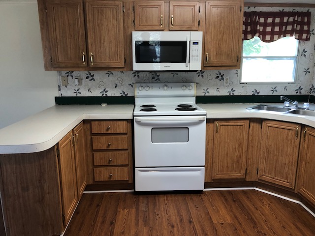 302 North Burnet Street Bremond, TX 76629 - Photo 8 of 41 a kitchen with stainless steel appliances a stove a sink and a microwave