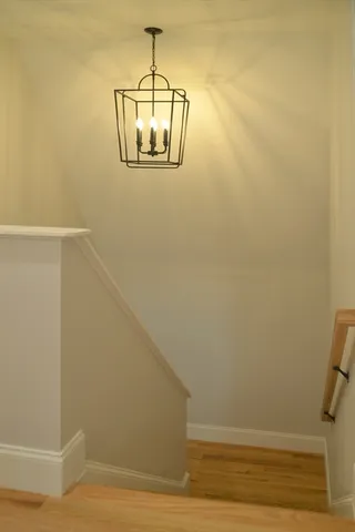 a view of a room with wooden floor and white walls